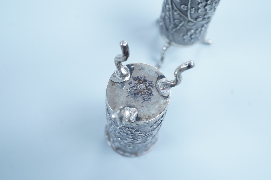 A pair of late 19th/early 20th century Chinese Export white metal cylindrical toothpick holders, by Wang Hing, Hong Kong, stamped 'WH90', on tripod feet, height 6cm.